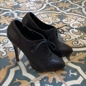Black lace-up heeled booties
